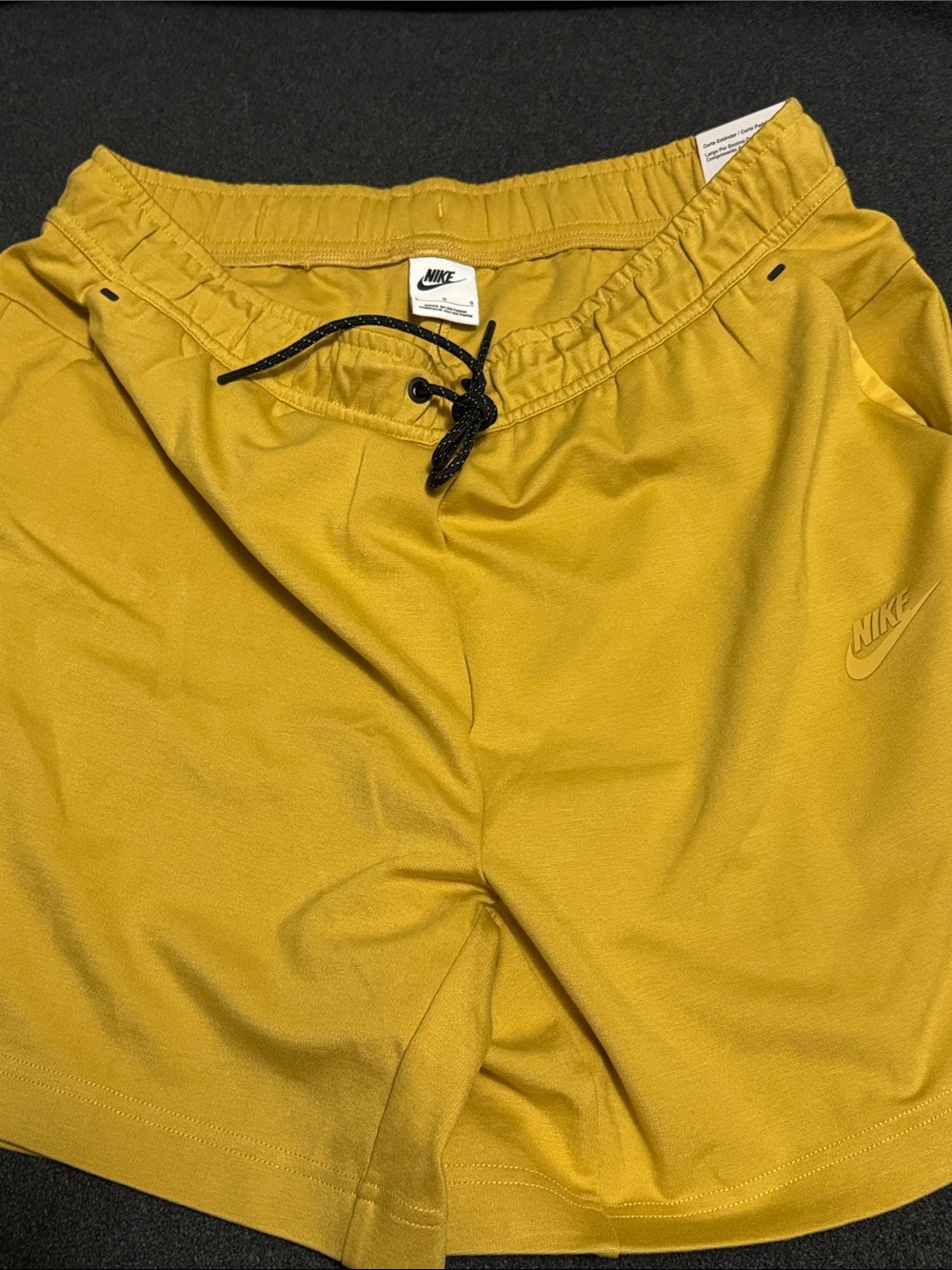 Nike Men's Large Gold Athletic Drawstring Shorts with Black accents.
